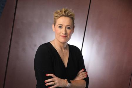 Claire Riley standing with arms folded.